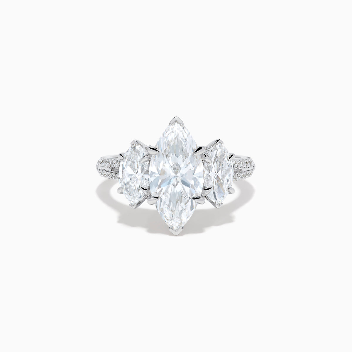 The Lab Grown Marquise Diamond 3 Stone Ring in 14K White Gold features a central marquise-cut lab grown diamond, two flanking marquise-cut diamonds, and two round diamonds set on a detailed band against a white background.