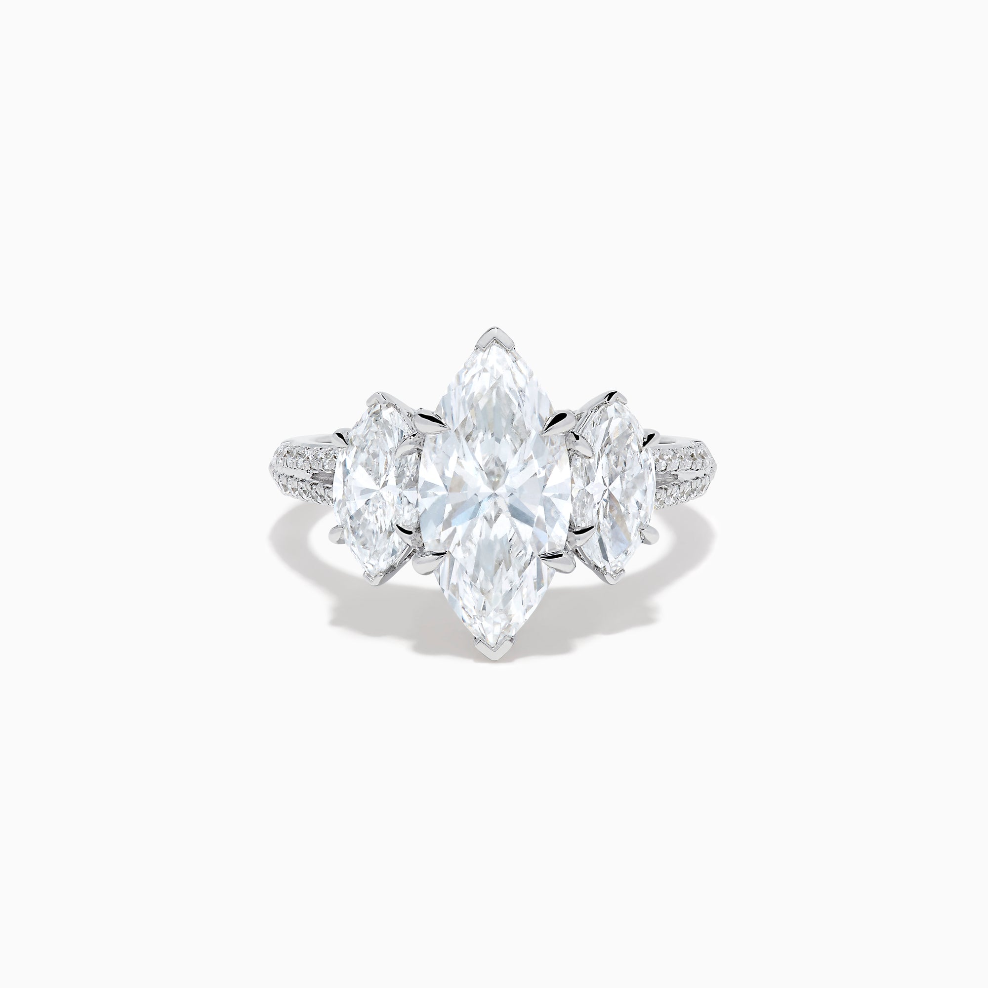 The Lab Grown Marquise Diamond 3 Stone Ring in 14K White Gold features a central marquise-cut lab grown diamond, two flanking marquise-cut diamonds, and two round diamonds set on a detailed band against a white background.