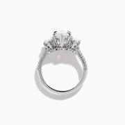 The Lab Grown Marquise Diamond 3 Stone Ring in 14K White Gold features a central marquise-cut lab grown diamond, two flanking marquise-cut diamonds, and two round diamonds set on a detailed band against a white background.