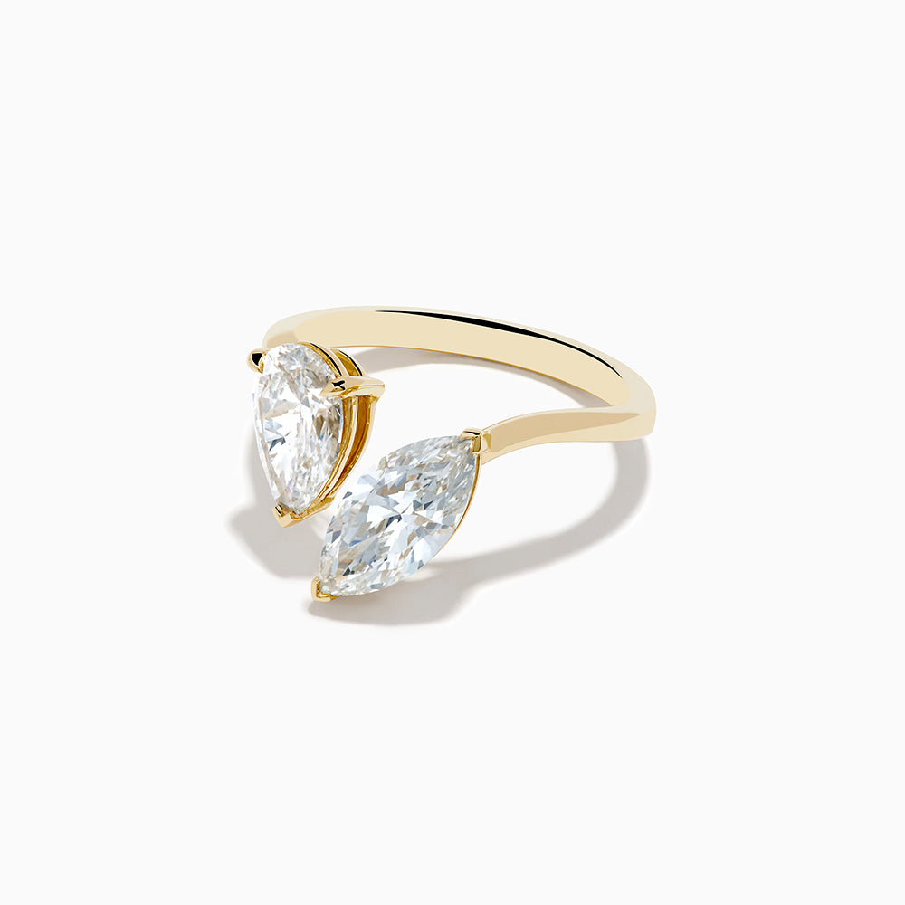 The Lab Grown Diamond Toi Et Moi Ring in 14K Yellow Gold features pear-shaped and marquise-cut lab diamonds set side by side, shown against a white background.