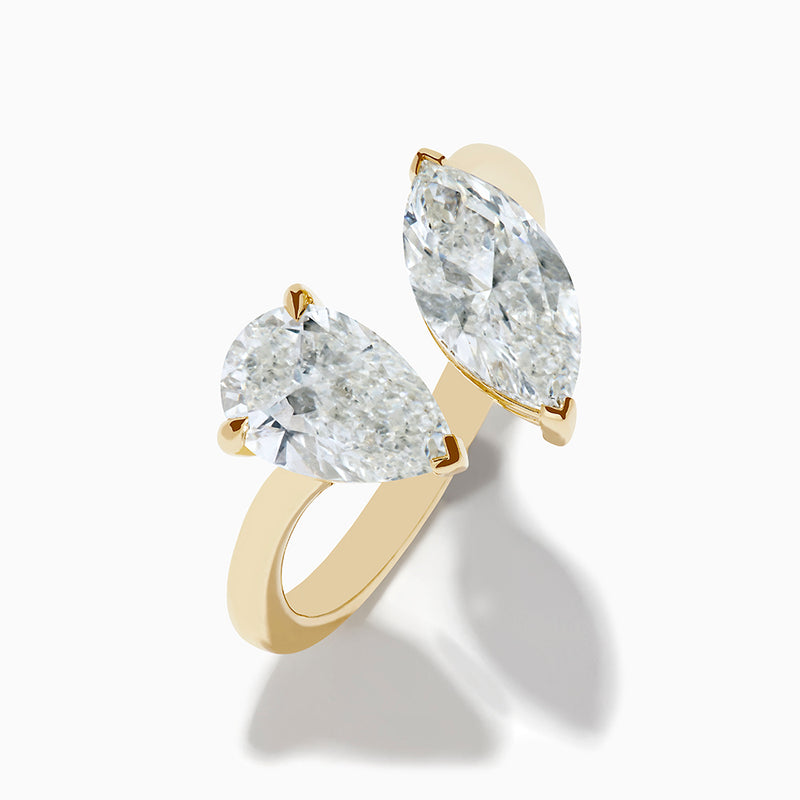 The Lab Grown Diamond Toi Et Moi Ring in 14K Yellow Gold features pear-shaped and marquise-cut lab diamonds set side by side, shown against a white background.