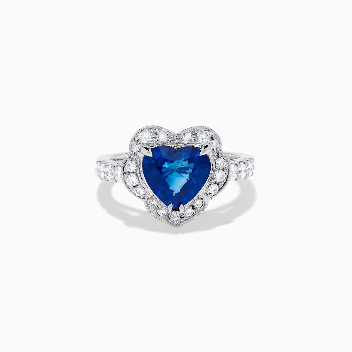 The Effy Hematian 18K White Gold Heart Shaped Blue Sapphire and Diamond Halo Ring features a heart-shaped blue sapphire center stone, a diamond halo, and additional diamonds along the band.