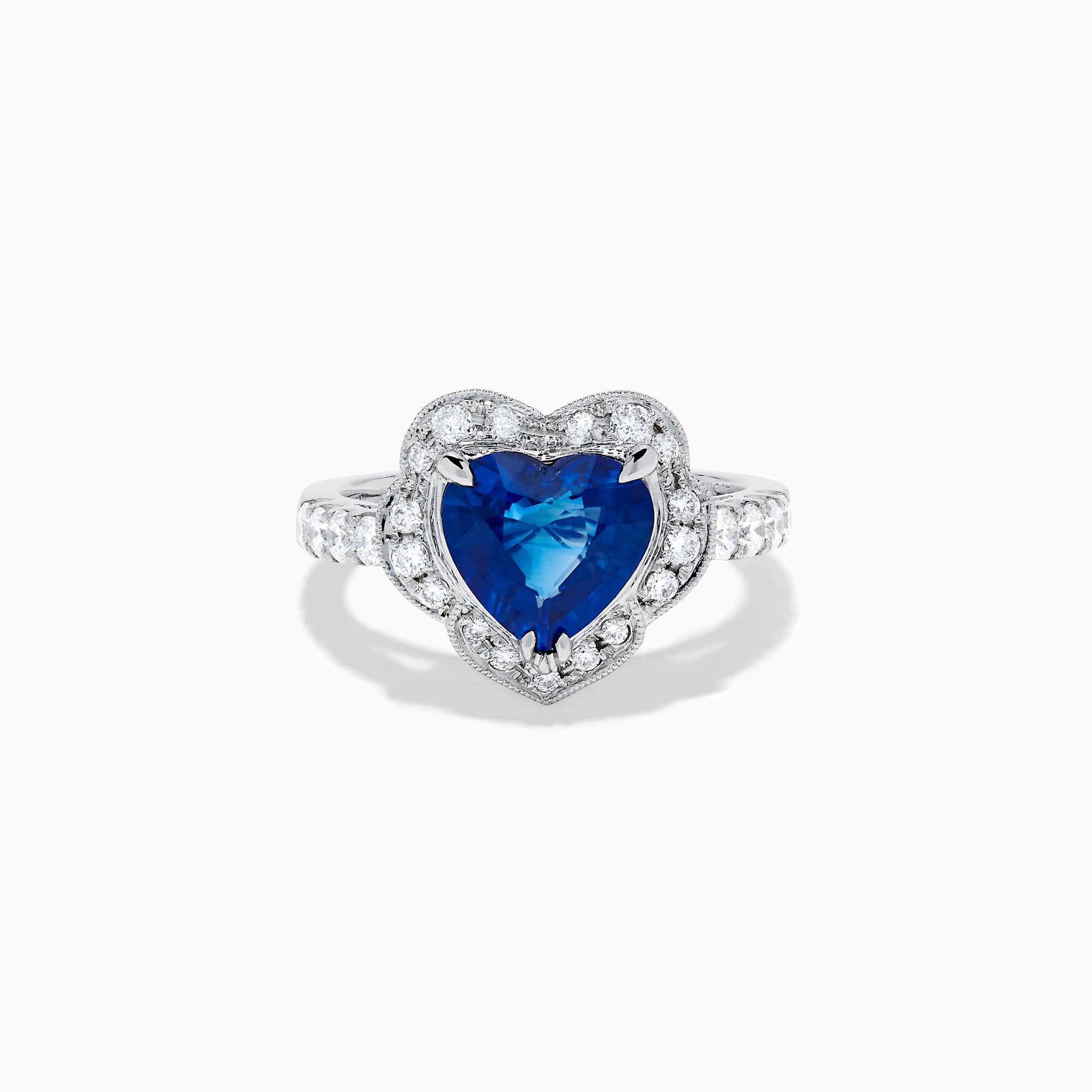 The Effy Hematian 18K White Gold Heart Shaped Blue Sapphire and Diamond Halo Ring features a heart-shaped blue sapphire center stone, a diamond halo, and additional diamonds along the band.