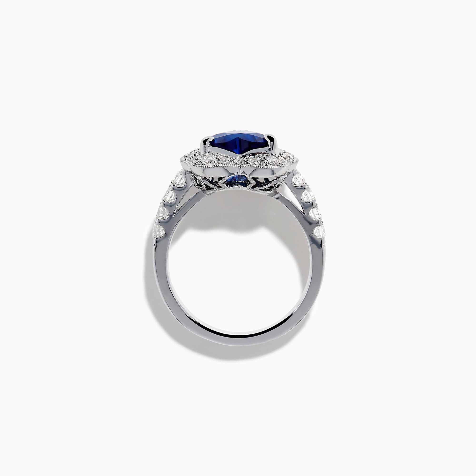 The Effy Hematian 18K White Gold Heart Shaped Blue Sapphire and Diamond Halo Ring features a heart-shaped blue sapphire center stone, a diamond halo, and additional diamonds along the band.