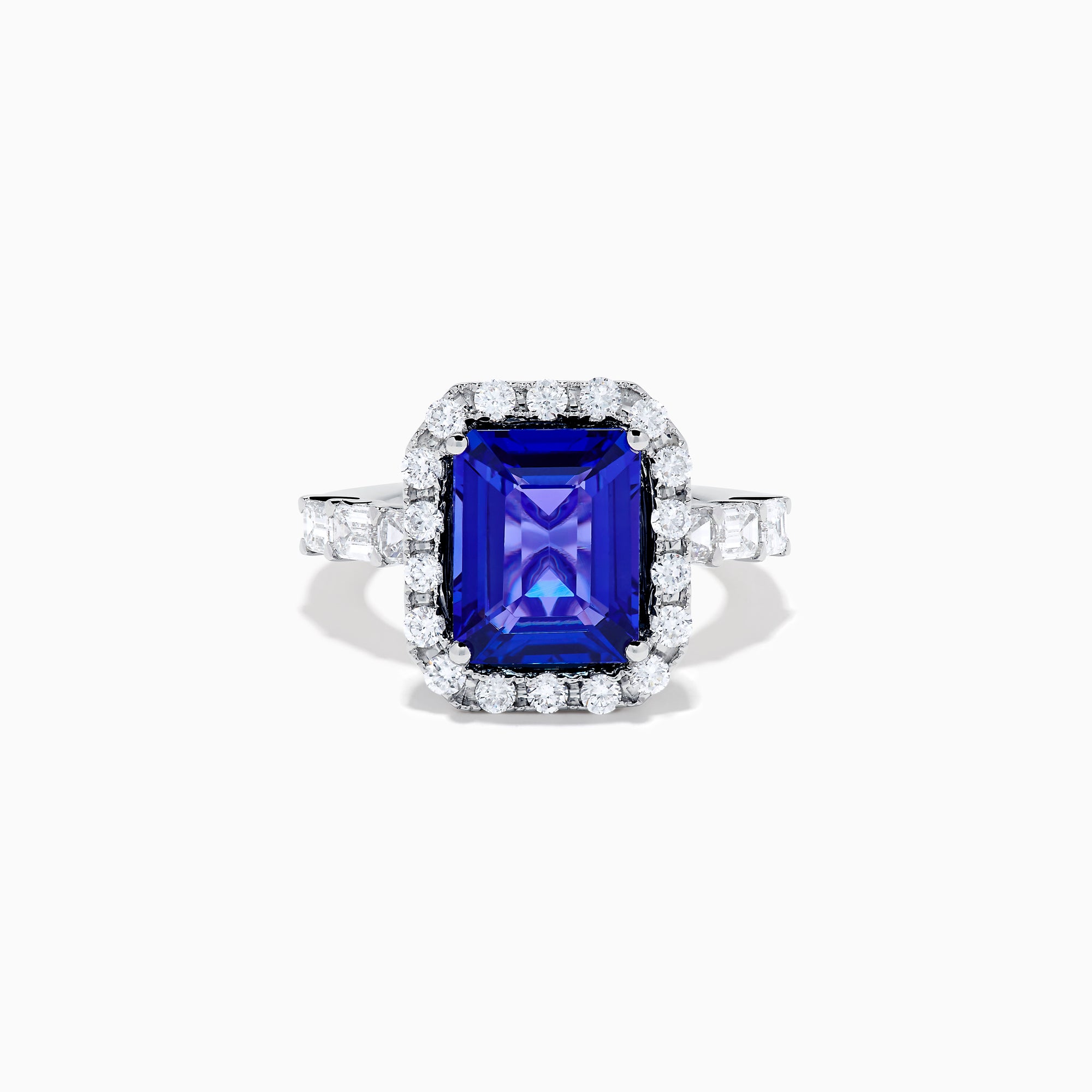 The Effy Hematian 18K White Gold Tanzanite and Diamond Halo Ring showcases a large rectangular blue tanzanite at the center, encircled by a diamond halo with additional diamonds set along the band.
