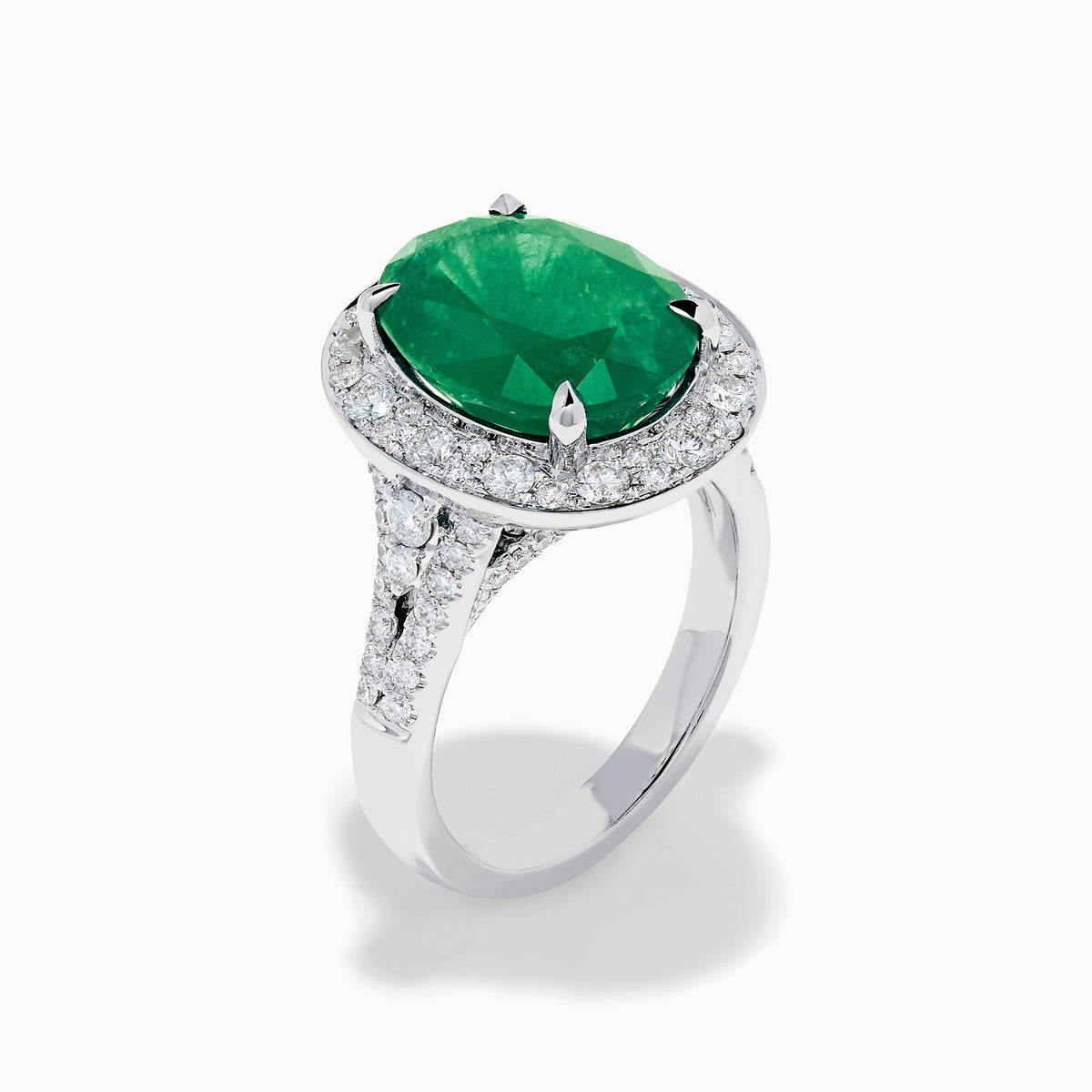 The Effy Hematian 18K White Gold Oval Emerald and Diamond Halo Ring is displayed against a pristine white background.