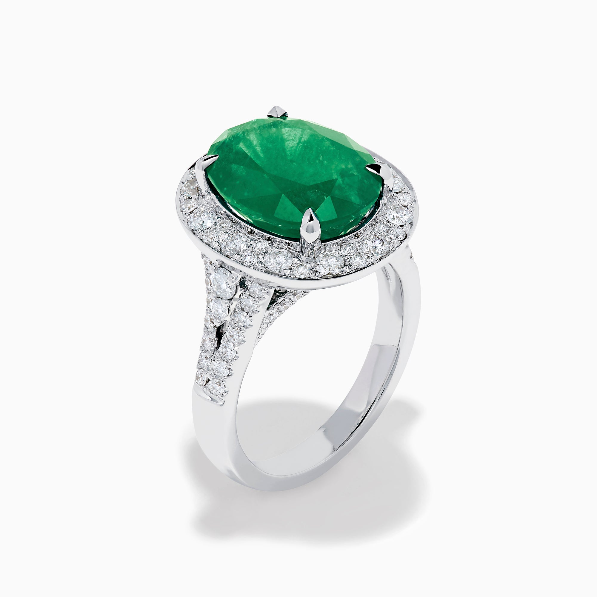 The Effy Hematian 18K White Gold Oval Emerald and Diamond Halo Ring is displayed against a pristine white background.