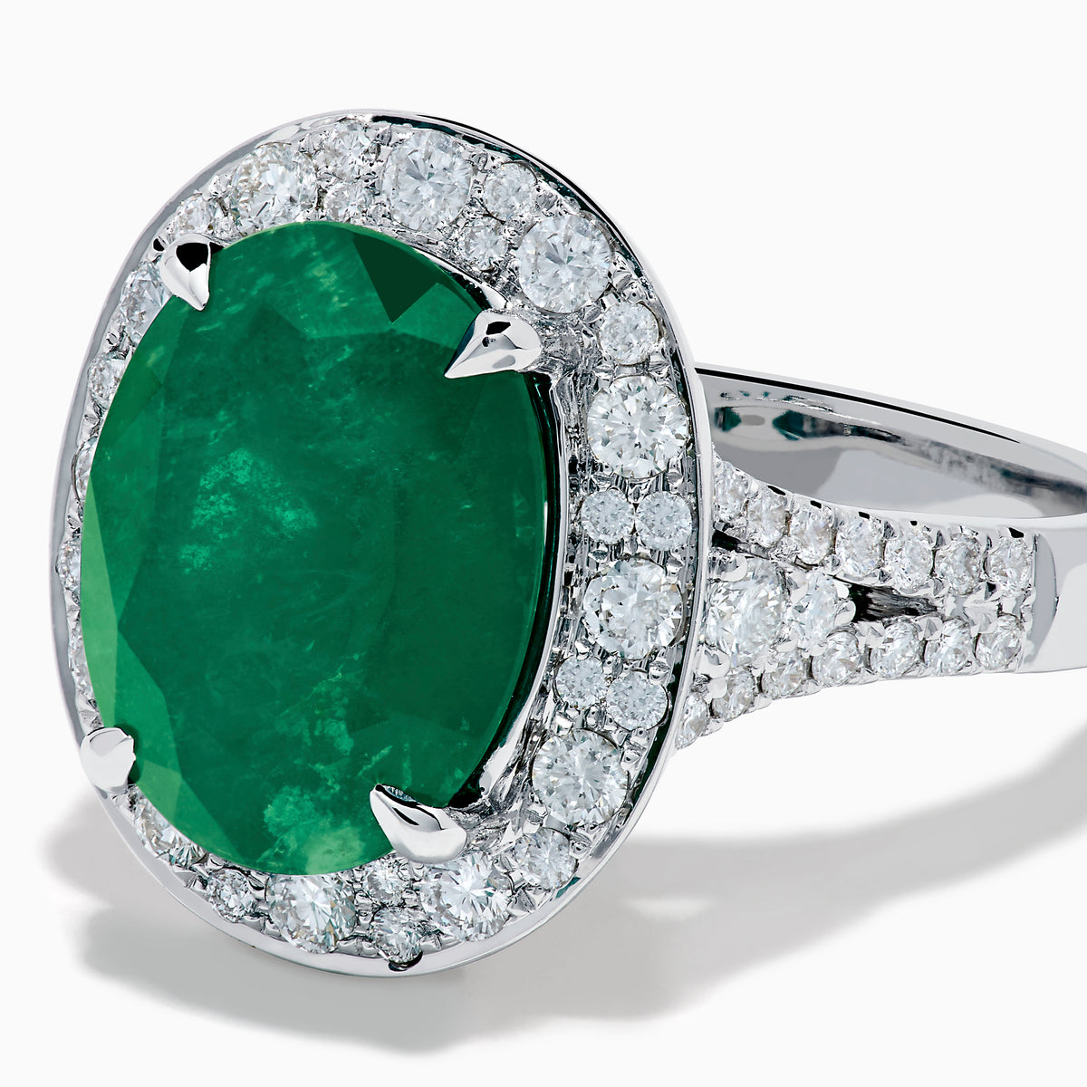 The Effy Hematian 18K White Gold Oval Emerald and Diamond Halo Ring is displayed against a pristine white background.
