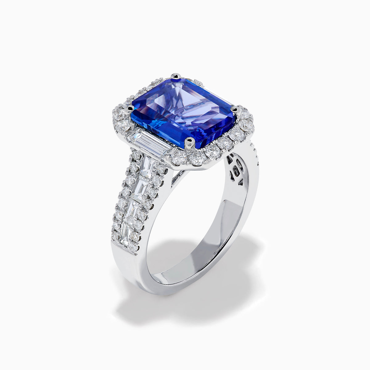 The Effy Hematian 18K White Gold Tanzanite and Diamond Halo Cocktail Ring is shown from the front, featuring an emerald-cut blue tanzanite with a diamond halo and diamond-accented band against a white background.