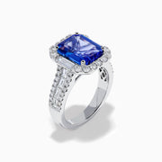 The Effy Hematian 18K White Gold Tanzanite and Diamond Halo Cocktail Ring is shown from the front, featuring an emerald-cut blue tanzanite with a diamond halo and diamond-accented band against a white background.