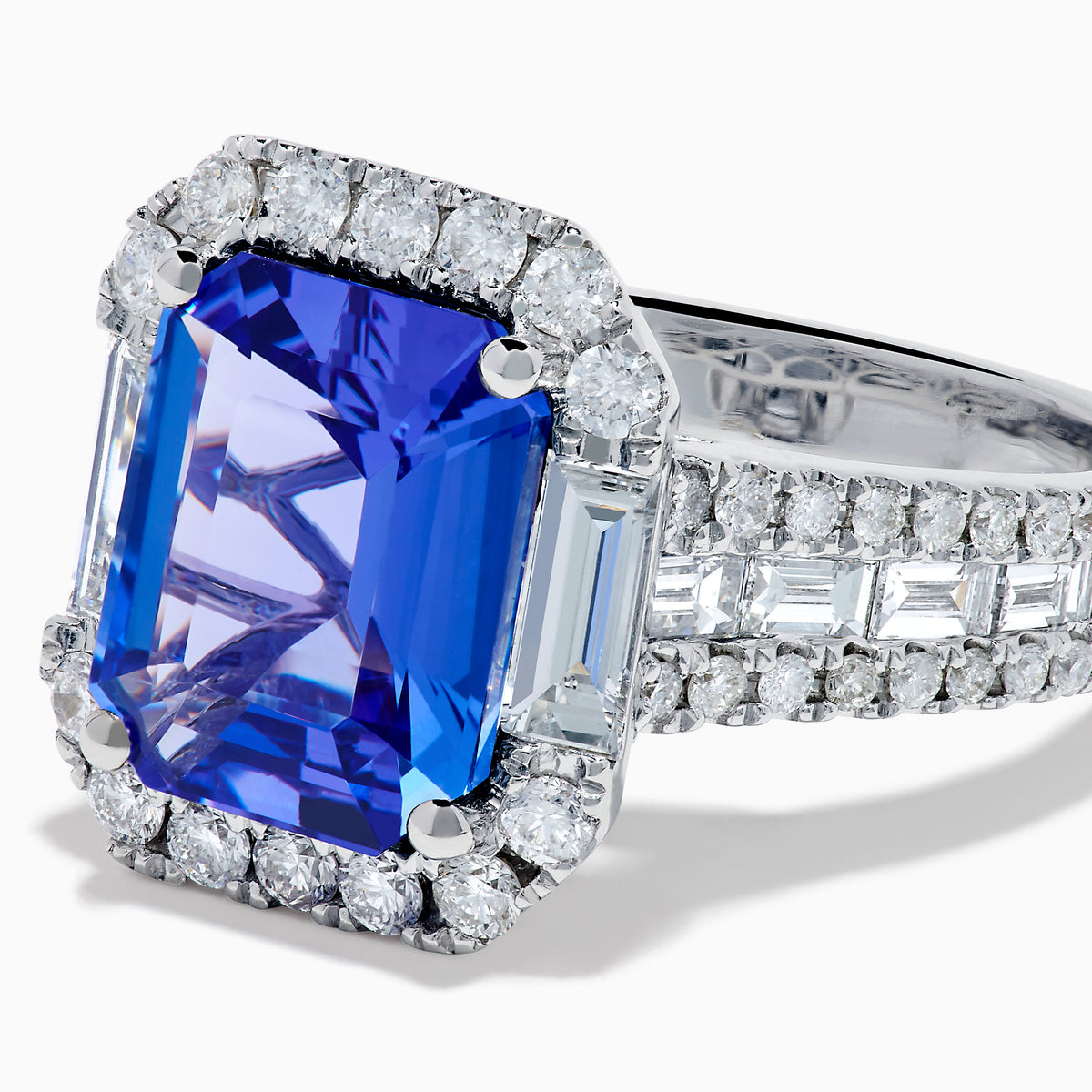 The Effy Hematian 18K White Gold Tanzanite and Diamond Halo Cocktail Ring is shown from the front, featuring an emerald-cut blue tanzanite with a diamond halo and diamond-accented band against a white background.