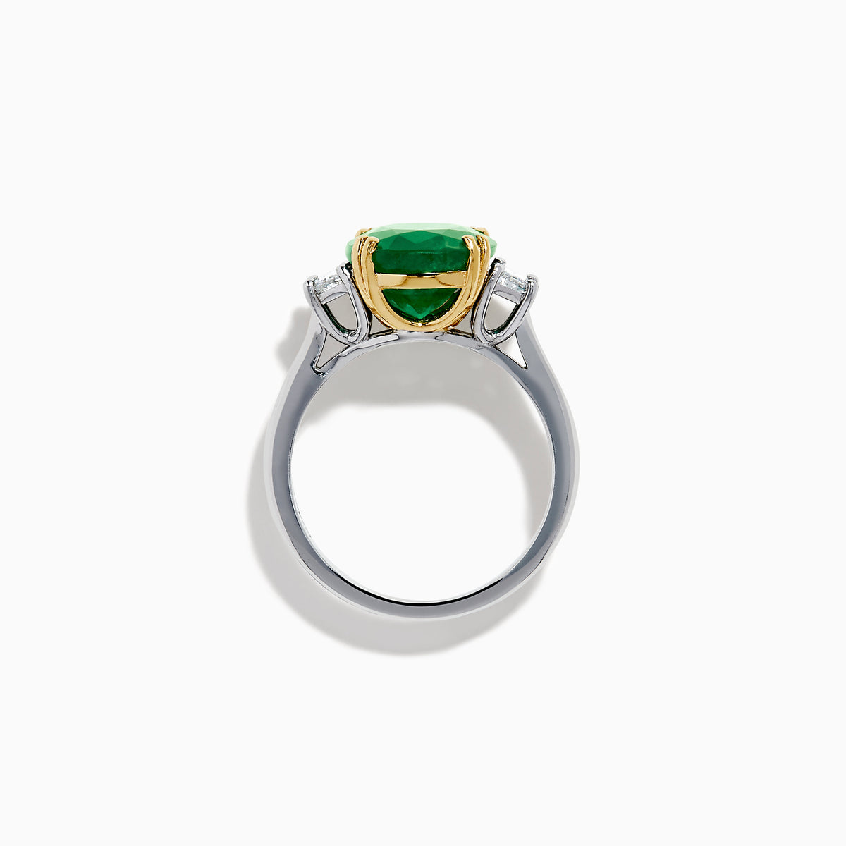 The Effy Hematian 14K Two Tone Gold Emerald and Diamond Three-Stone Ring features a large oval emerald center set with four gold prongs, flanked by two clear rectangular diamonds on a gold and silver band.