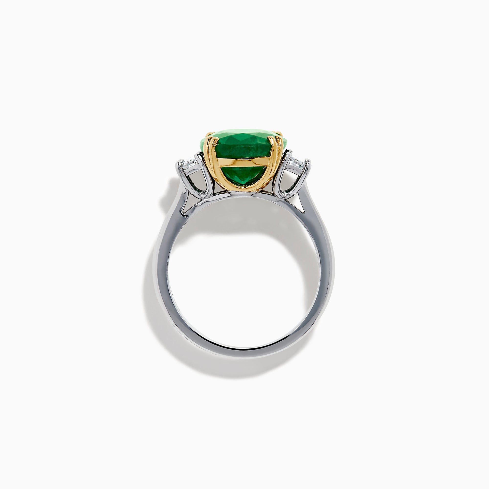 The Effy Hematian 14K Two Tone Gold Emerald and Diamond Three-Stone Ring features a large oval emerald center set with four gold prongs, flanked by two clear rectangular diamonds on a gold and silver band.