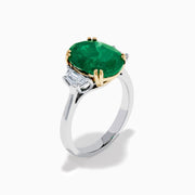 The Effy Hematian 14K Two Tone Gold Emerald and Diamond Three-Stone Ring features a large oval emerald center set with four gold prongs, flanked by two clear rectangular diamonds on a gold and silver band.