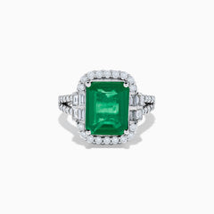 The Effy Hematian 14K White Gold Emerald and Diamond Cocktail Ring showcases a rectangular emerald surrounded by round and baguette diamonds on a sleek white gold band, displayed against a white background.