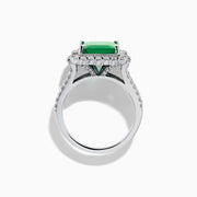 The Effy Hematian 14K White Gold Emerald and Diamond Cocktail Ring showcases a rectangular emerald surrounded by round and baguette diamonds on a sleek white gold band, displayed against a white background.