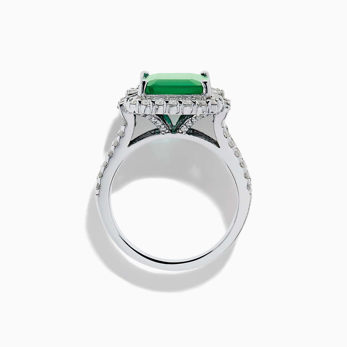 The Effy Hematian 14K White Gold Emerald and Diamond Cocktail Ring showcases a rectangular emerald surrounded by round and baguette diamonds on a sleek white gold band, displayed against a white background.