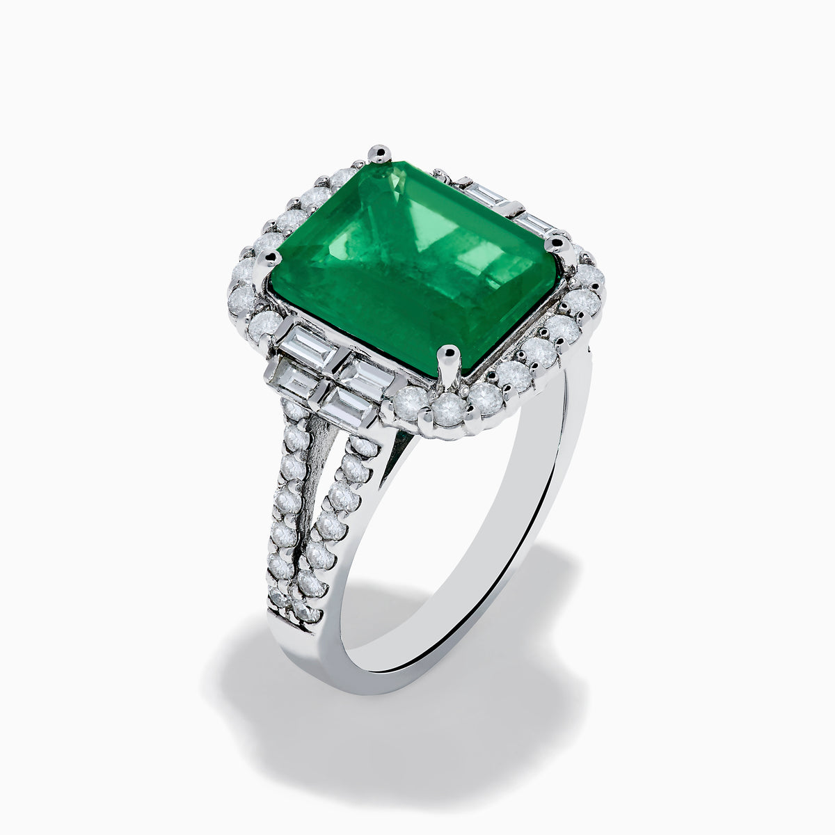 The Effy Hematian 14K White Gold Emerald and Diamond Cocktail Ring showcases a rectangular emerald surrounded by round and baguette diamonds on a sleek white gold band, displayed against a white background.