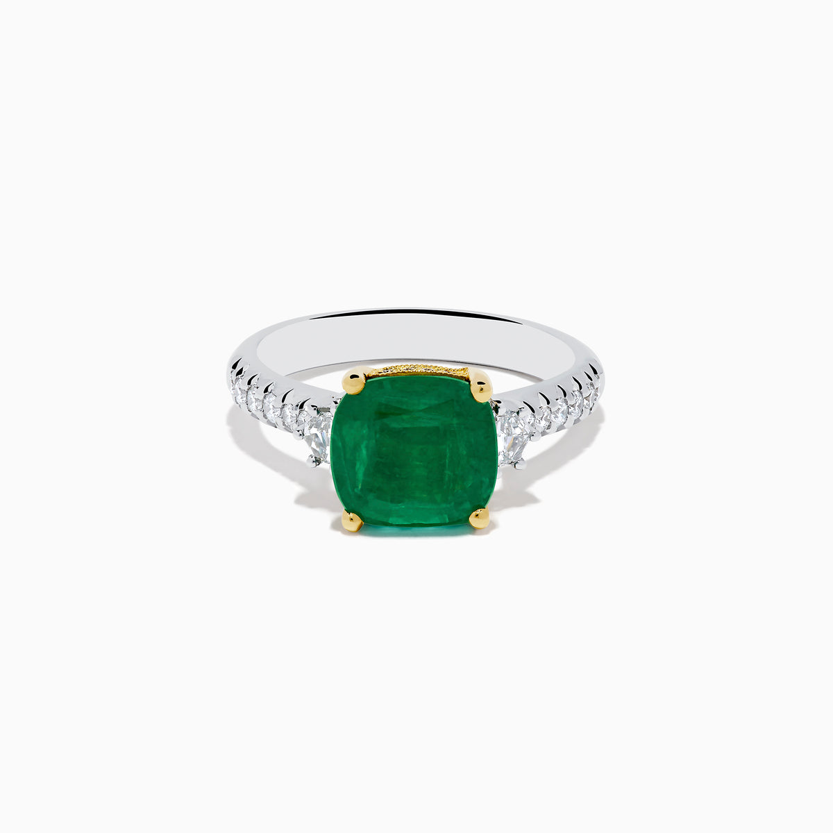 The 18K Two Tone Gold Emerald and Diamond Ring features a large square-cut green emerald in an 18K gold prong setting, with a white metal band accented by small round diamonds on each side.