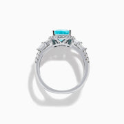 The Effy Hematian 14K White Gold Paraiba and Diamond Criss Cross Ring features a stunning pear-shaped Paraiba gemstone at its center with sparkling diamonds, all set on an elegant split shank band against a white background.