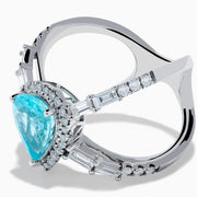 The Effy Hematian 14K White Gold Paraiba and Diamond Criss Cross Ring features a stunning pear-shaped Paraiba gemstone at its center with sparkling diamonds, all set on an elegant split shank band against a white background.