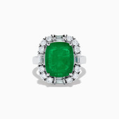 The Brasilica 14K White Gold Emerald and Diamond Ring features a large rectangular emerald center, surrounded by a halo of round and baguette-cut white diamonds, set on sleek 14K white gold.