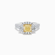 The Canare 18K Two Tone Gold White and Yellow Diamond Ring features a cushion-cut yellow diamond center, haloed by white diamonds, with extra diamonds along the split 18K gold band.