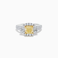 The Canare 18K Two Tone Gold White and Yellow Diamond Ring features a cushion-cut yellow diamond center, haloed by white diamonds, with extra diamonds along the split 18K gold band.
