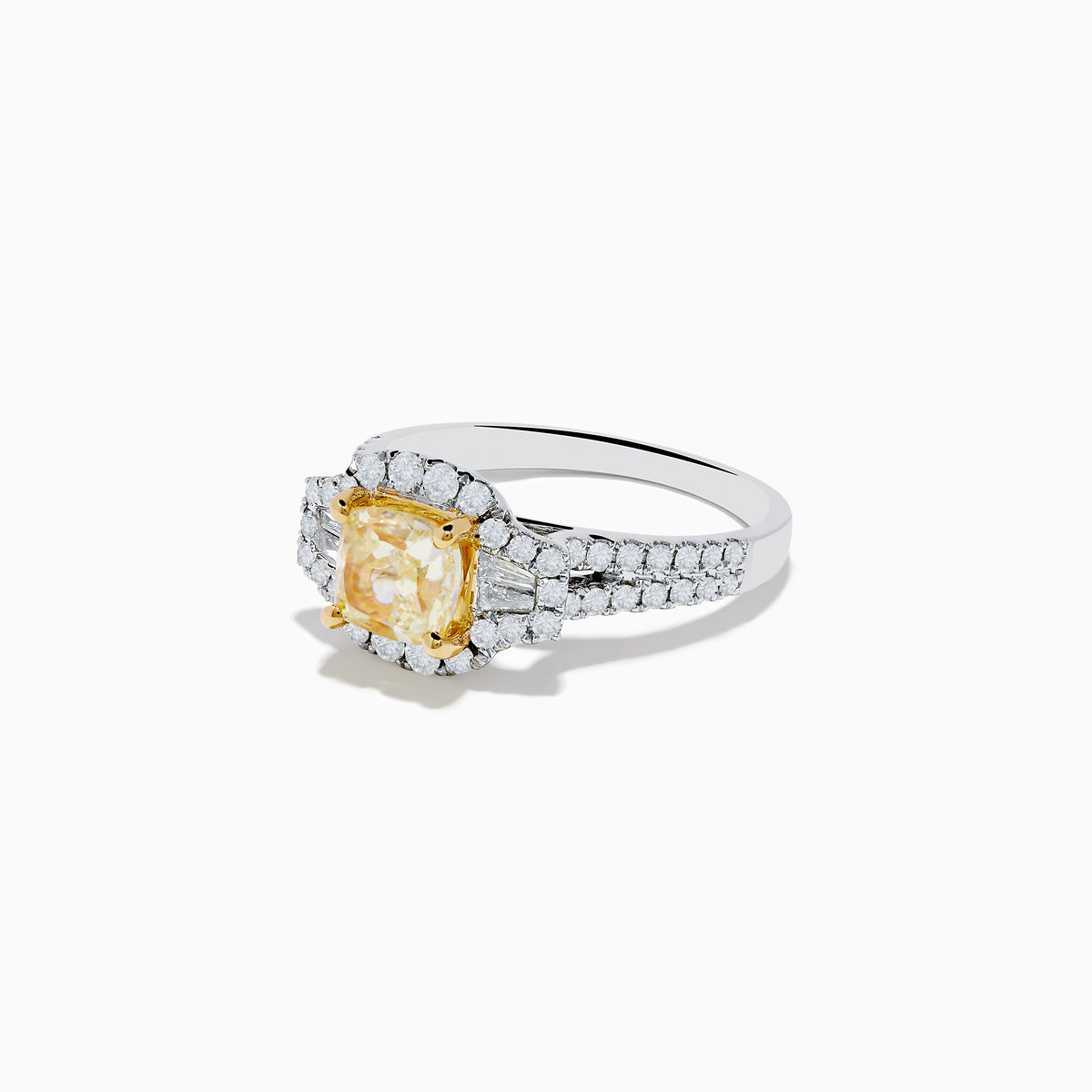 The Canare 18K Two Tone Gold White and Yellow Diamond Ring features a cushion-cut yellow diamond center, haloed by white diamonds, with extra diamonds along the split 18K gold band.