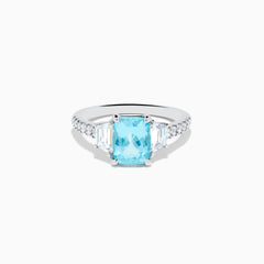 The Effy Hematian 18K White Gold Paraiba Tourmaline and Diamond Ring showcases a vibrant, large rectangular tourmaline center stone, flanked by two side diamonds and a band adorned with small round diamonds.