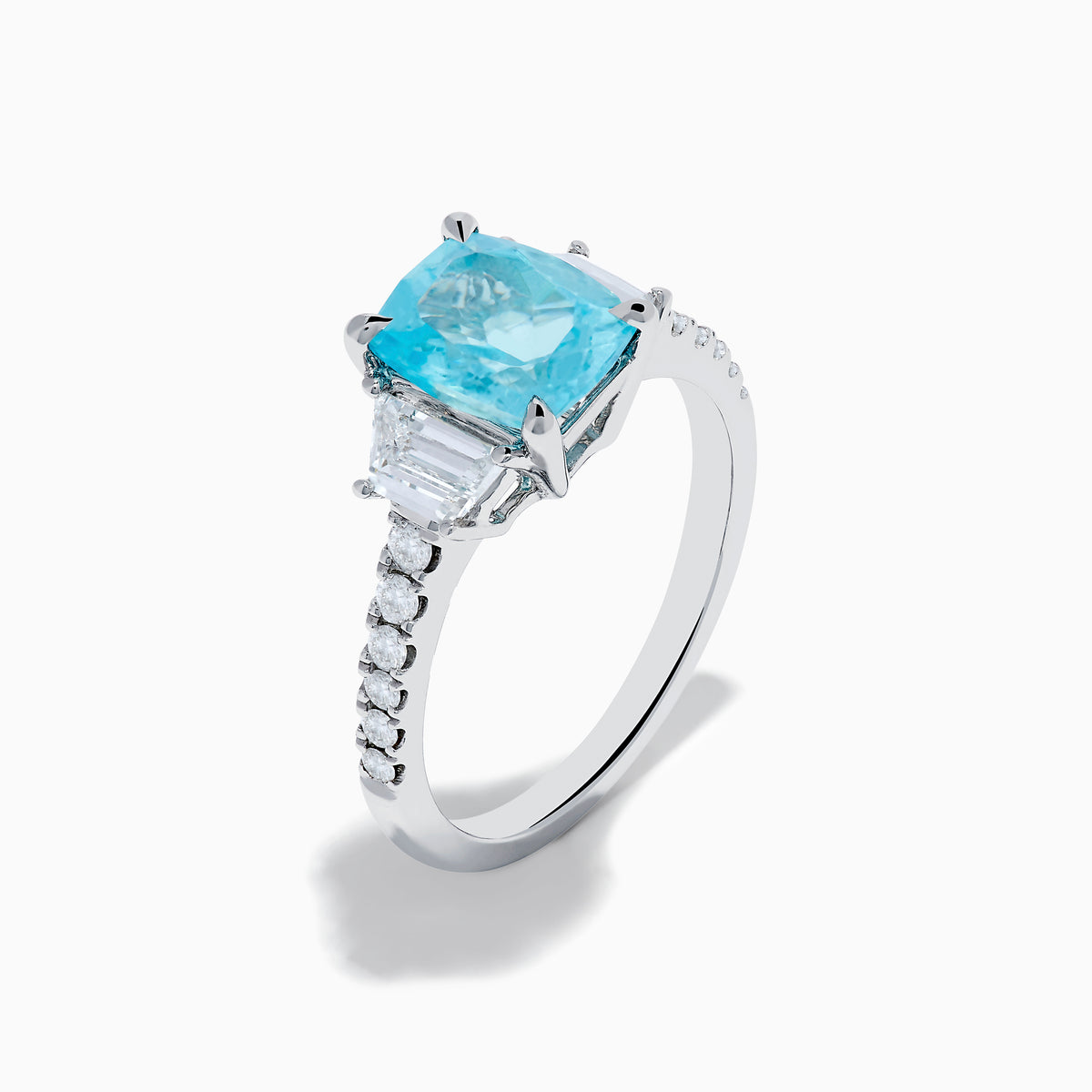 The Effy Hematian 18K White Gold Paraiba Tourmaline and Diamond Ring showcases a vibrant, large rectangular tourmaline center stone, flanked by two side diamonds and a band adorned with small round diamonds.
