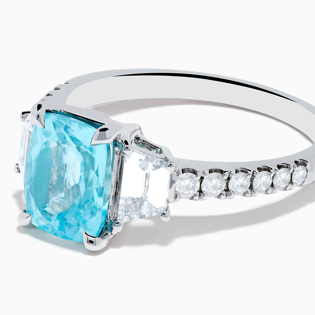 The Effy Hematian 18K White Gold Paraiba Tourmaline and Diamond Ring showcases a vibrant, large rectangular tourmaline center stone, flanked by two side diamonds and a band adorned with small round diamonds.