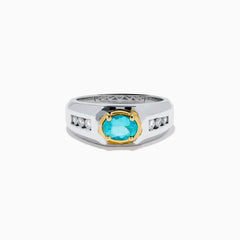 A mens 18K two tone GIA certified Paraiba and diamond ring featuring an oval Paraiba gemstone in a gold setting, accented by three diamonds on each side, displayed on a white background.