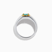 A mens 18K two tone GIA certified Paraiba and diamond ring featuring an oval Paraiba gemstone in a gold setting, accented by three diamonds on each side, displayed on a white background.