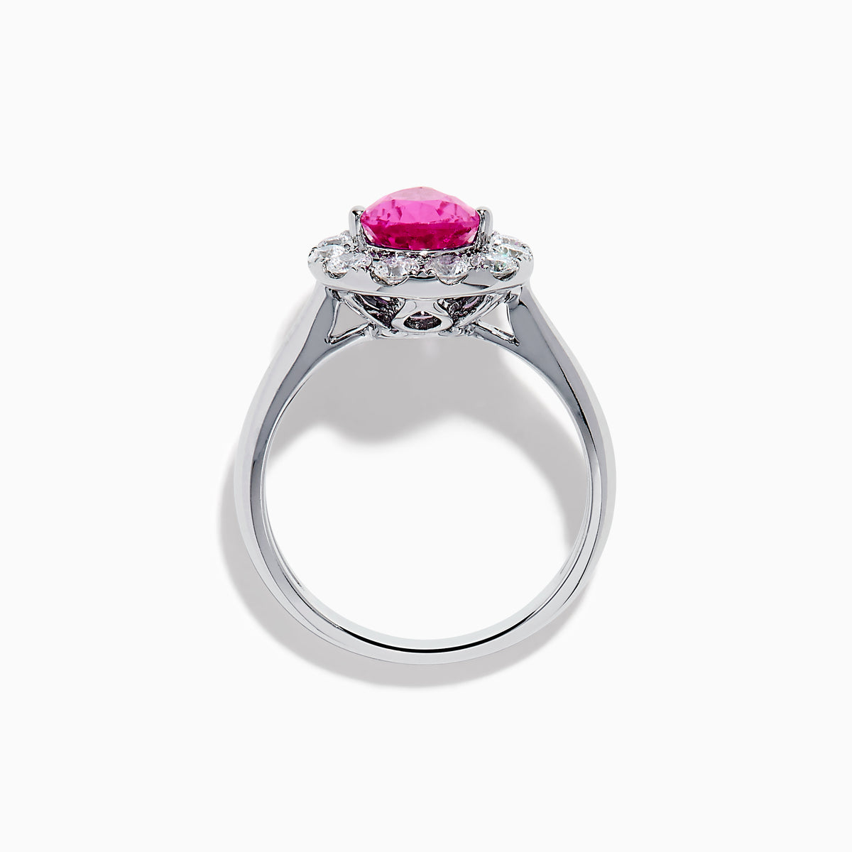 The 18K White Gold Pink Sapphire and Diamond Halo Ring features a pear-shaped pink sapphire center, accented by a sparkling diamond halo, elegantly displayed against a plain white background.