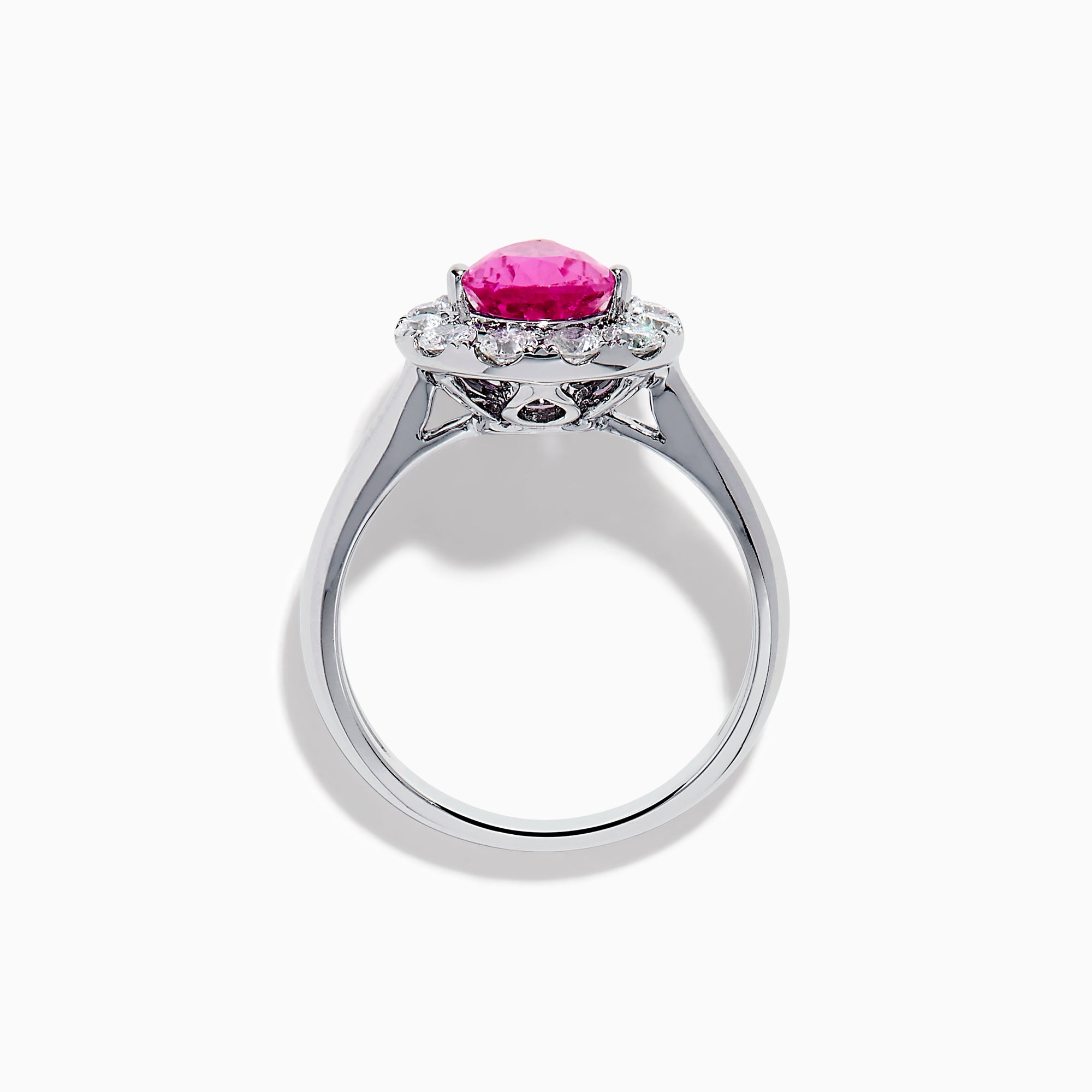 The 18K White Gold Pink Sapphire and Diamond Halo Ring features a pear-shaped pink sapphire center, accented by a sparkling diamond halo, elegantly displayed against a plain white background.