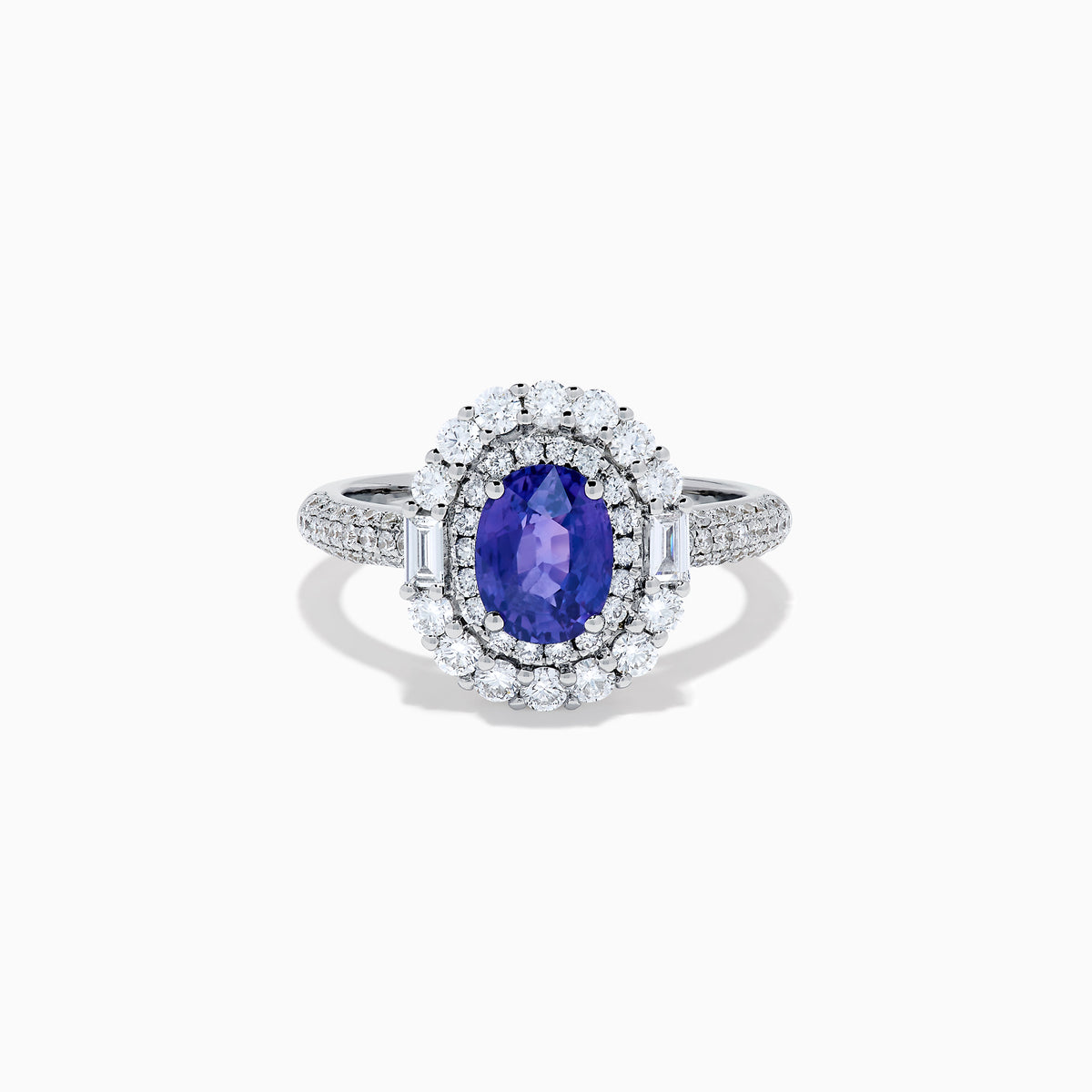 The 18K White Gold Purple Sapphire and Diamond Double Halo Ring features an oval purple sapphire center, two rows of white diamonds encircling it, and additional diamonds set along the band.