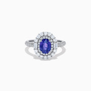 The 18K White Gold Purple Sapphire and Diamond Double Halo Ring features an oval purple sapphire center, two rows of white diamonds encircling it, and additional diamonds set along the band.