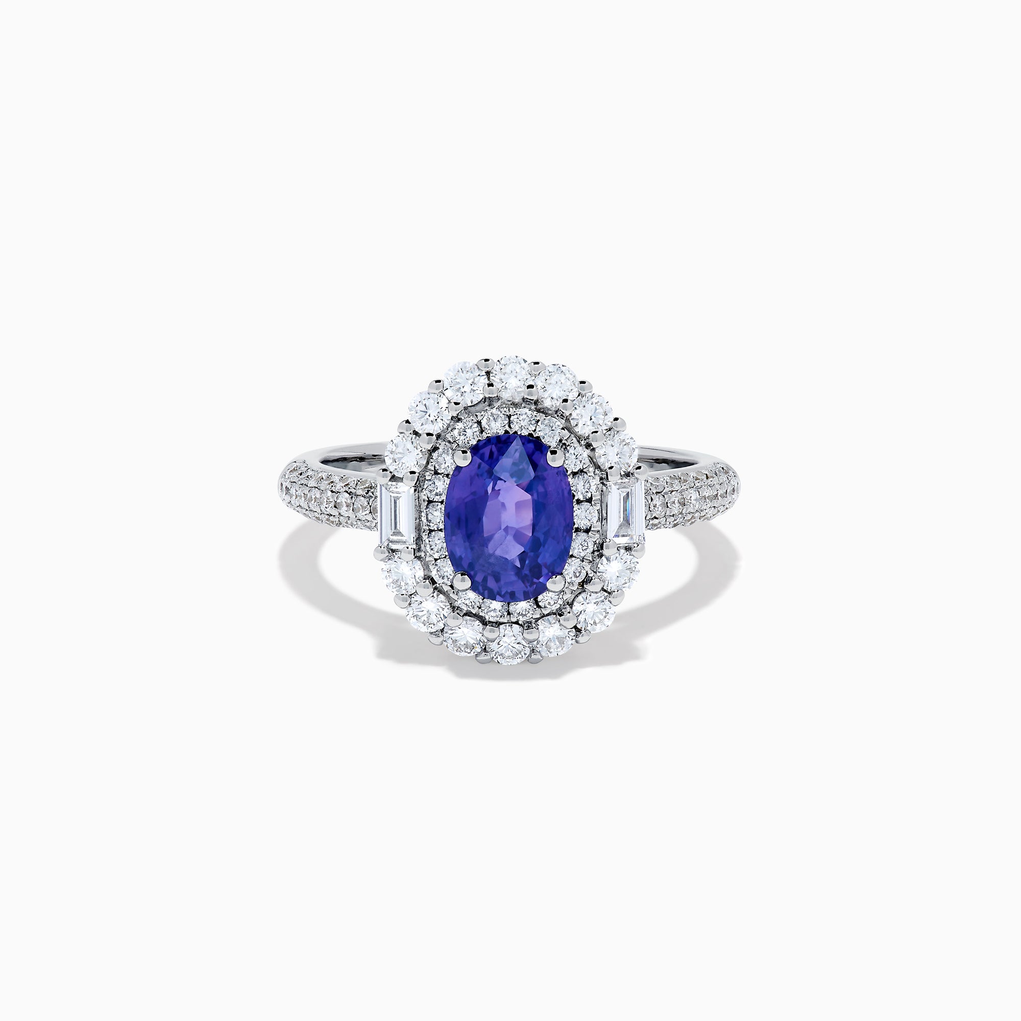 The 18K White Gold Purple Sapphire and Diamond Double Halo Ring features an oval purple sapphire center, two rows of white diamonds encircling it, and additional diamonds set along the band.