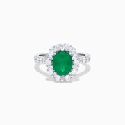The Effy Hematian 18K White Gold Oval Emerald and Diamond Halo Ring features a vibrant oval emerald at the center, surrounded by a sparkling diamond halo with additional diamonds set along the elegant band.