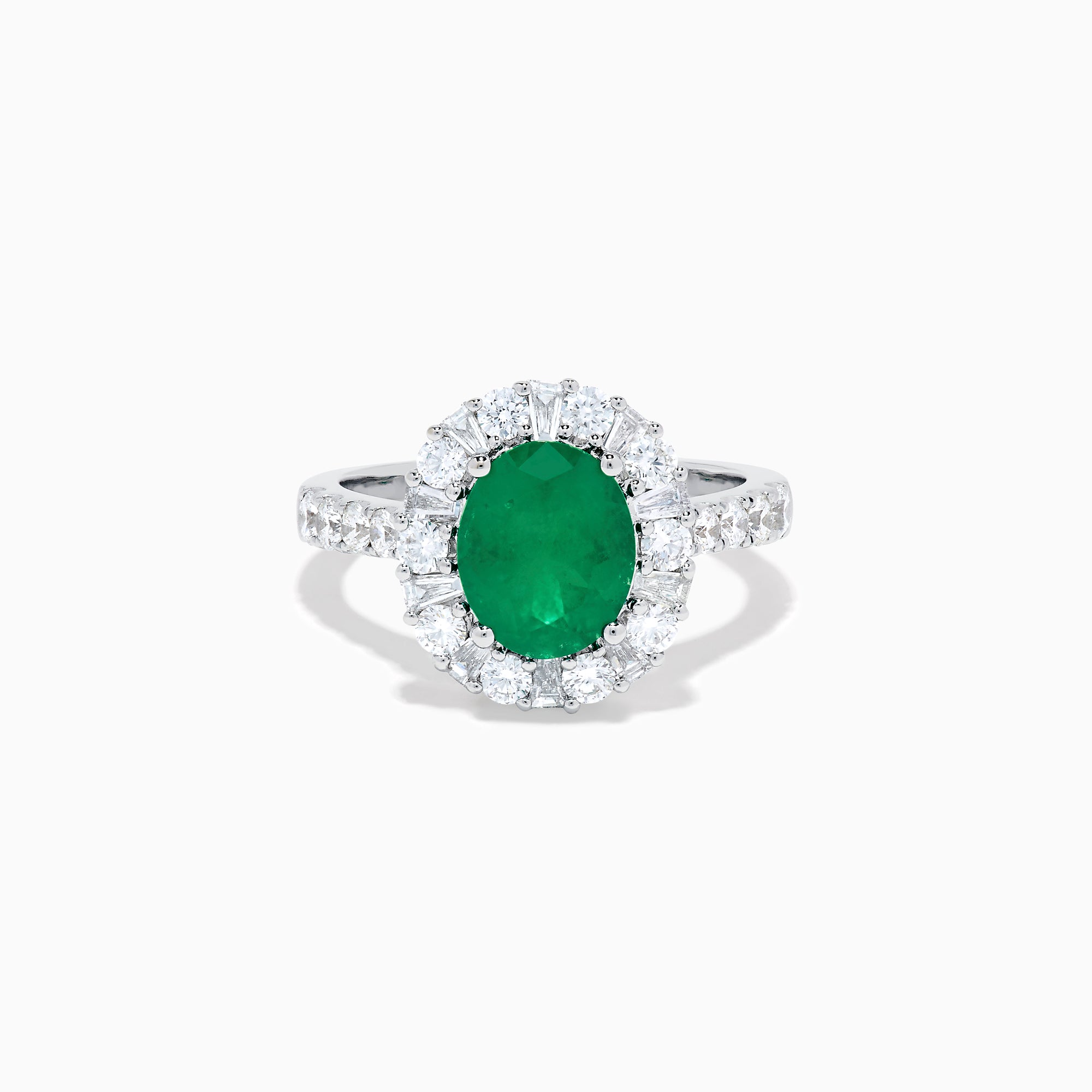 The Effy Hematian 18K White Gold Oval Emerald and Diamond Halo Ring features a vibrant oval emerald at the center, surrounded by a sparkling diamond halo with additional diamonds set along the elegant band.