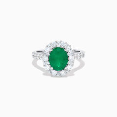 The Effy Hematian 18K White Gold Oval Emerald and Diamond Halo Ring features a vibrant oval emerald at the center, surrounded by a sparkling diamond halo with additional diamonds set along the elegant band.