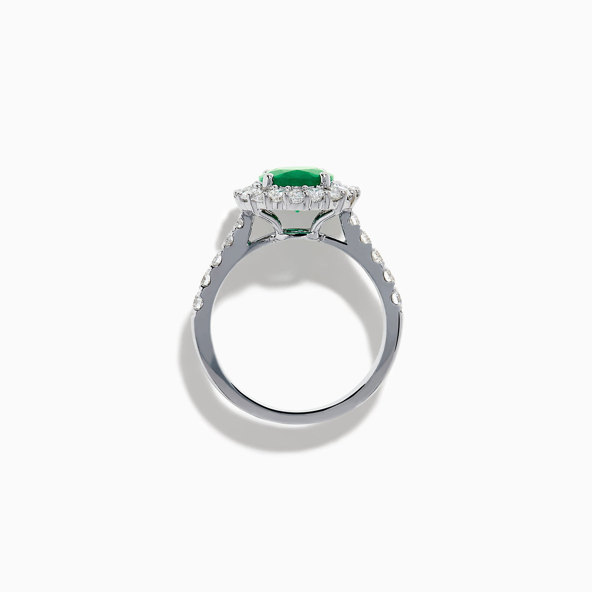 The Effy Hematian 18K White Gold Oval Emerald and Diamond Halo Ring features a vibrant oval emerald at the center, surrounded by a sparkling diamond halo with additional diamonds set along the elegant band.