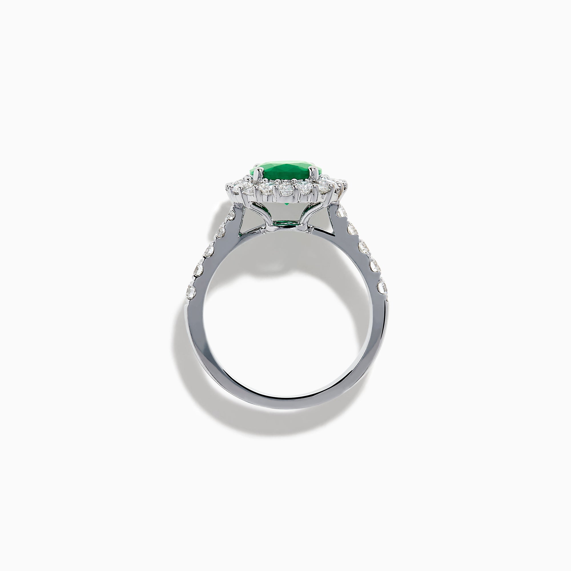 The Effy Hematian 18K White Gold Oval Emerald and Diamond Halo Ring features a vibrant oval emerald at the center, surrounded by a sparkling diamond halo with additional diamonds set along the elegant band.