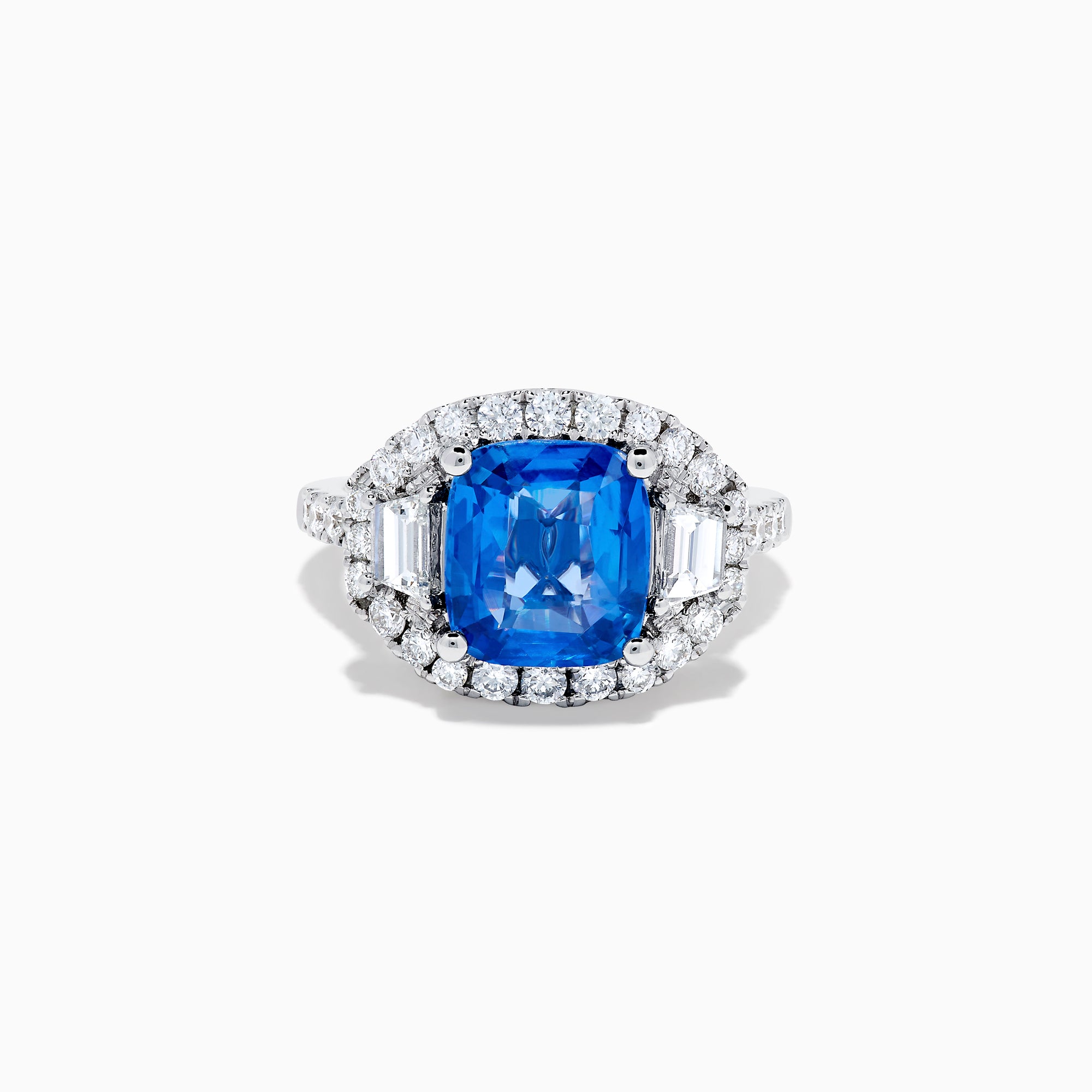 The Effy Hematian 18K Gold Cushion-Cut Blue Sapphire and Diamond Ring features a striking cushion-cut blue sapphire surrounded by a halo of round and baguette diamonds, all set in polished white 18K gold.