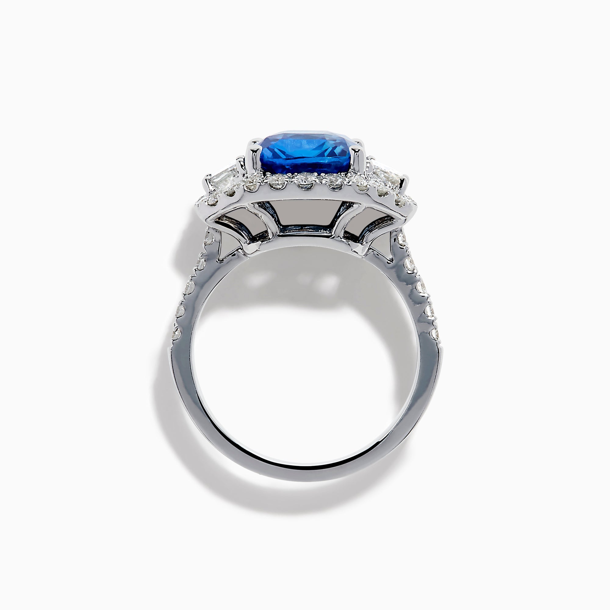 The Effy Hematian 18K Gold Cushion-Cut Blue Sapphire and Diamond Ring features a striking cushion-cut blue sapphire surrounded by a halo of round and baguette diamonds, all set in polished white 18K gold.