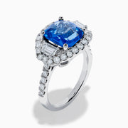 The Effy Hematian 18K Gold Cushion-Cut Blue Sapphire and Diamond Ring features a striking cushion-cut blue sapphire surrounded by a halo of round and baguette diamonds, all set in polished white 18K gold.