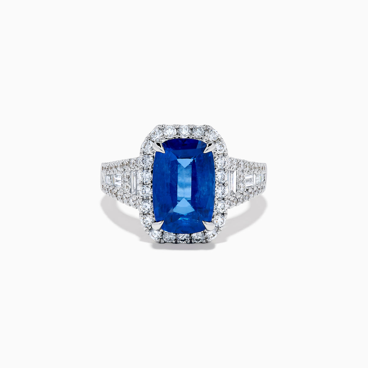 The Effy Hematian 18K Gold Elongated Cushion Blue Sapphire and Diamond Ring features a striking blue sapphire framed by round and baguette diamonds, with additional diamond accents along the split shank band.