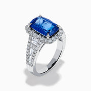 The Effy Hematian 18K Gold Elongated Cushion Blue Sapphire and Diamond Ring features a striking blue sapphire framed by round and baguette diamonds, with additional diamond accents along the split shank band.