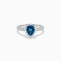 The Effy Hematian 18K White Gold Ring features a pear-shaped blue sapphire, surrounded by a halo of diamonds and set on a diamond-studded band, elegantly displayed against a white background.